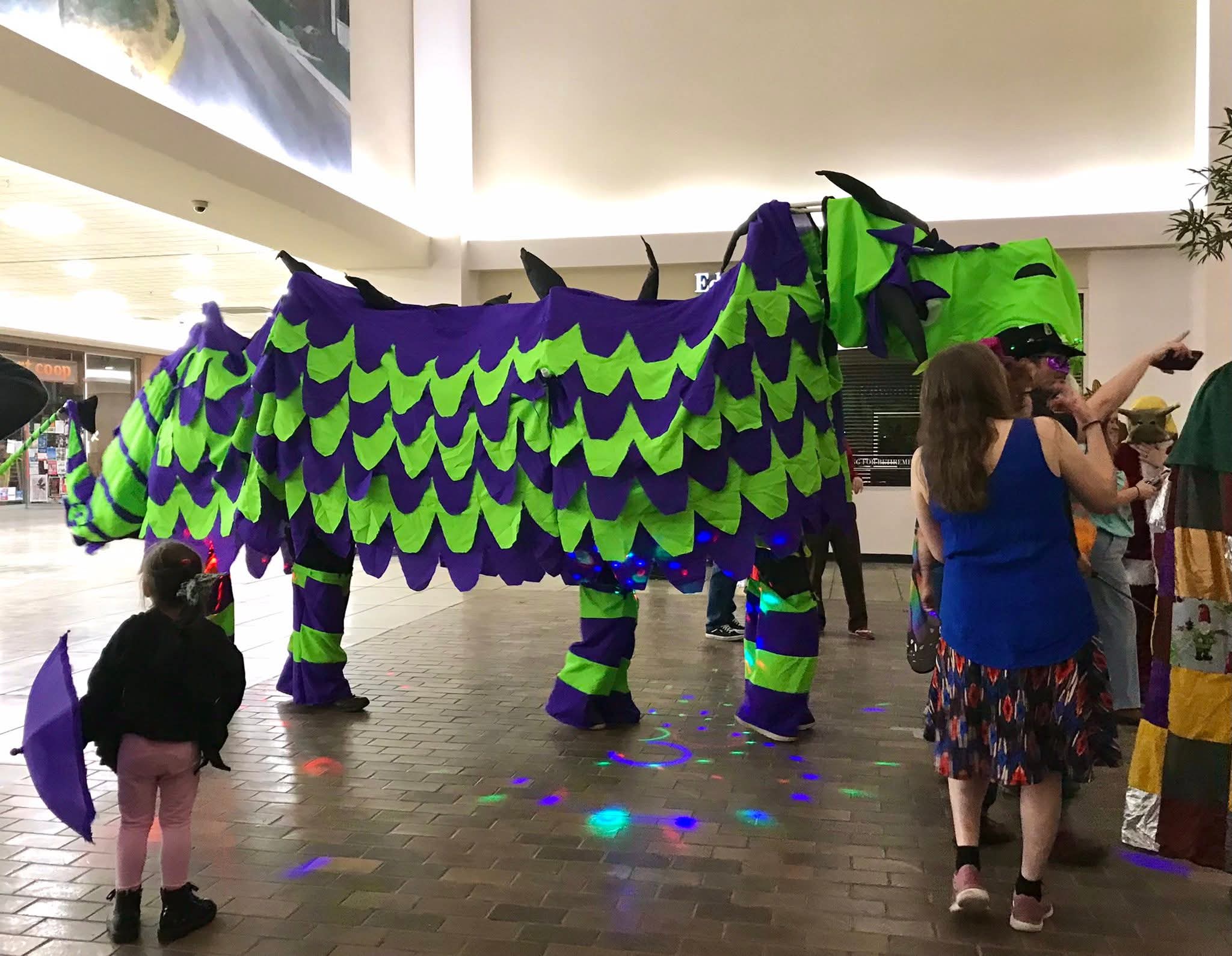 Gertie the dragon at fabrikatefest, child looking up in awe