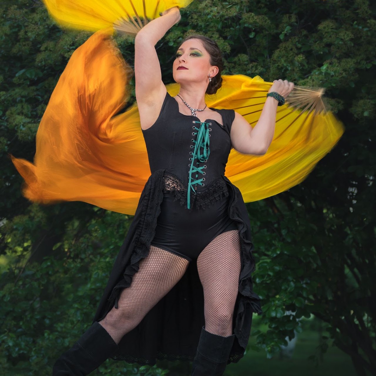 CU Circus Collective fan dancer with flowing yellow fans