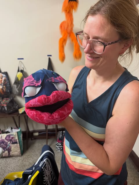 Member of C-U Puppet People holding a handmade puppet